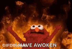 Elmo From Sesame Street Is Standing In Front Of A Fire . GIF
