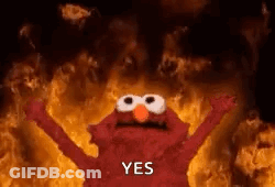 Elmo From Sesame Street Is Standing In Front Of A Fire With His Arms In The Air . GIF