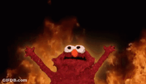 Elmo From Sesame Street Is Standing In Front Of A Fire With His Arms Outstretched GIF