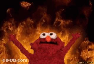 Elmo From Sesame Street Is Standing In Front Of A Fire With His Arms Outstretched GIF
