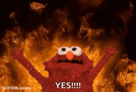 Elmo From Sesame Street Is Standing In Front Of A Fire With His Arms Outstretched And Saying Yes . GIF