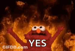 Elmo From Sesame Street Is Standing In Front Of A Fire With His Arms Outstretched . GIF