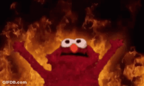 Elmo From Sesame Street Is Standing In Front Of A Fire With His Arms Outstretched . GIF