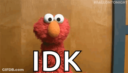 Elmo From Sesame Street Is Standing In Front Of A Wooden Wall And Says `` Idk '' . GIF
