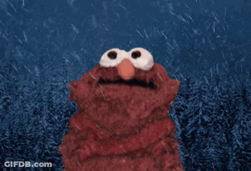 Elmo From Sesame Street Is Standing In The Rain With Trees In The Background GIF