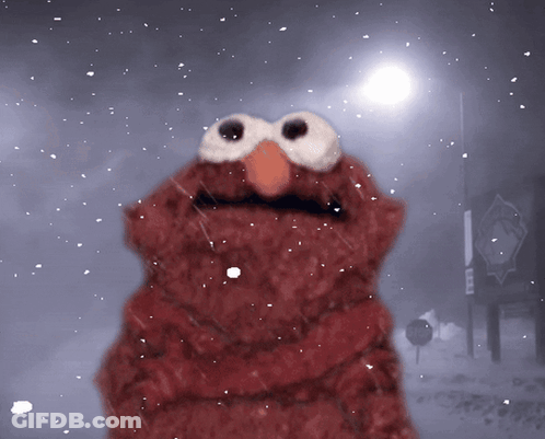 Elmo From Sesame Street Is Standing In The Snow In Front Of A Sign That Says No Parking GIF