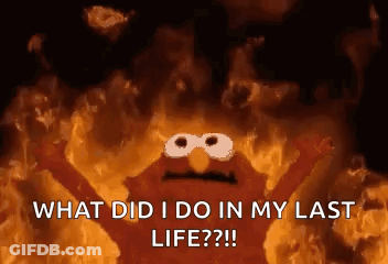 Elmo From Sesame Street Is Surrounded By Flames And Is Asking What Did I Do In My Last Life ? GIF