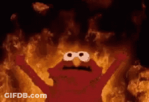 Elmo From Sesame Street Is Surrounded By Flames In A Cave . GIF
