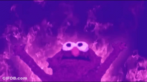 Elmo From Sesame Street Is Surrounded By Flames In A Dark Room . GIF