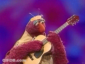 Elmo From Sesame Street Playing A Guitar On Stage GIF