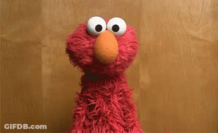 Elmo From Sesame Street Says " I 'M An Idiot " In Front Of A Wooden Background GIF