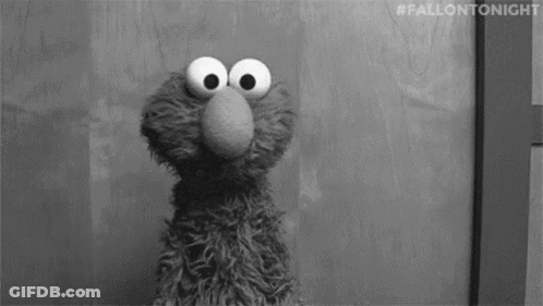 Elmo From Sesame Street Standing In Front Of Door Looking At Camera GIF