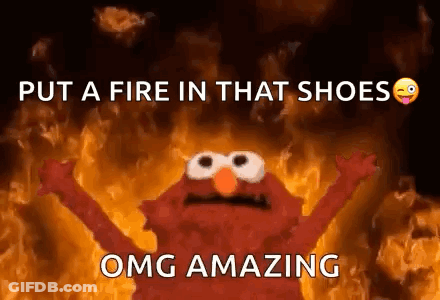 Elmo From Sesame Street Standing In Front Of Fire GIF
