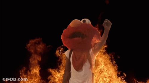Elmo From Sesame Street Standing In Front Of Flames GIF