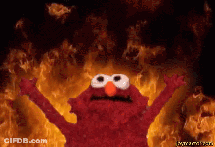 Elmo From Sesame Street Standing In Front Of Wall Of Fire GIF