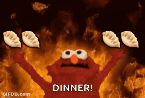 Elmo Holding Dumplings In Front Of Fire Saying Dinner GIF
