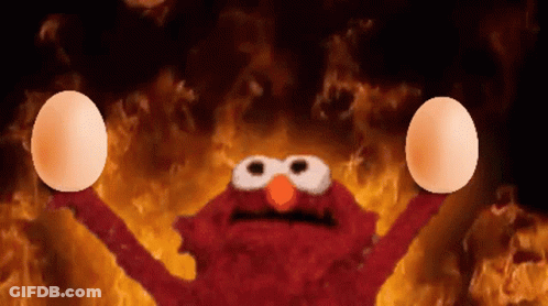 Elmo Holding Eggs In Front Of Flames GIF