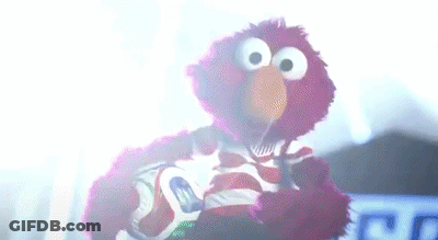 Elmo Holding Soccer Ball In Dark Room GIF