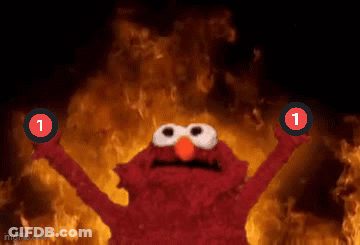 Elmo Is Holding Up Two Red Circles With The Number 1 On Them In Front Of A Fire GIF