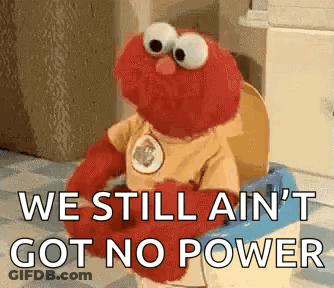 Elmo Is Sitting On A Toilet With The Words `` We Still Ain 'T Got No Power '' . GIF