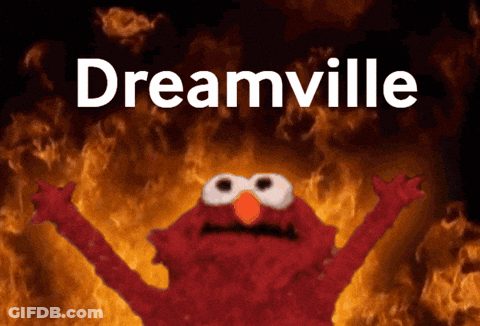 Elmo Is Standing In Front Of A Fire And The Word Dreamville Is Above Him GIF