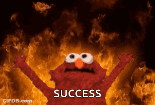 Elmo Is Standing In Front Of A Fire And The Word Success Is On The Bottom GIF