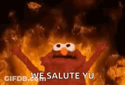 Elmo Is Standing In Front Of A Fire With His Arms Outstretched . GIF