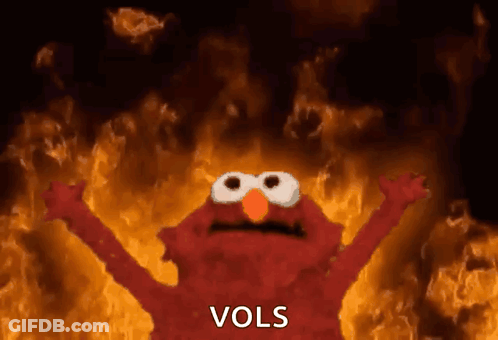 Elmo Is Standing In Front Of A Fire With The Word Vols Written On The Bottom GIF