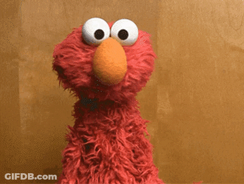 Elmo Says It 'S A Friday Thing In Front Of A Brown Wall GIF