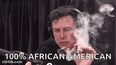 Elon Musk Is Smoking A Cigarette In Front Of A Microphone . GIF