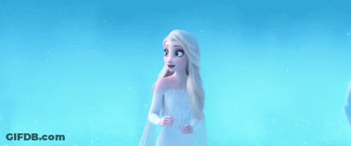 Elsa From Frozen 2 Is Standing In The Snow Wearing A White Dress . GIF