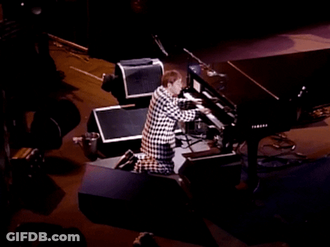 Elton John Kneeling While Playing Piano GIF