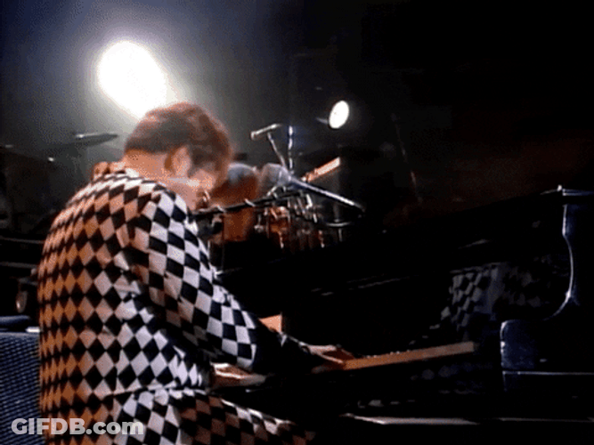 Elton John Stretching Both Arms GIF