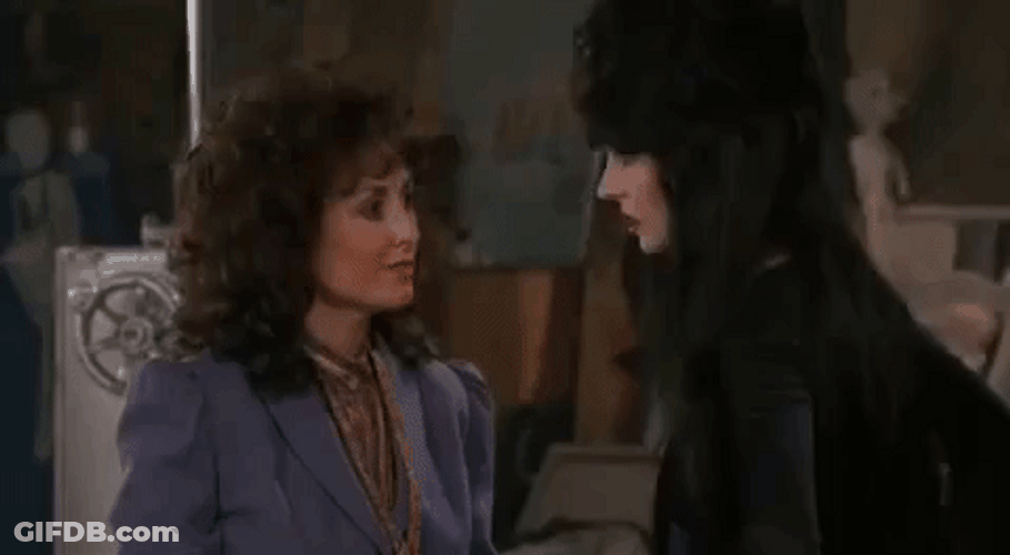 Elvira Going Past Anchorwoman GIF