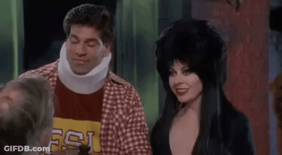 Elvira Kissing A Man On The Forehead GIF