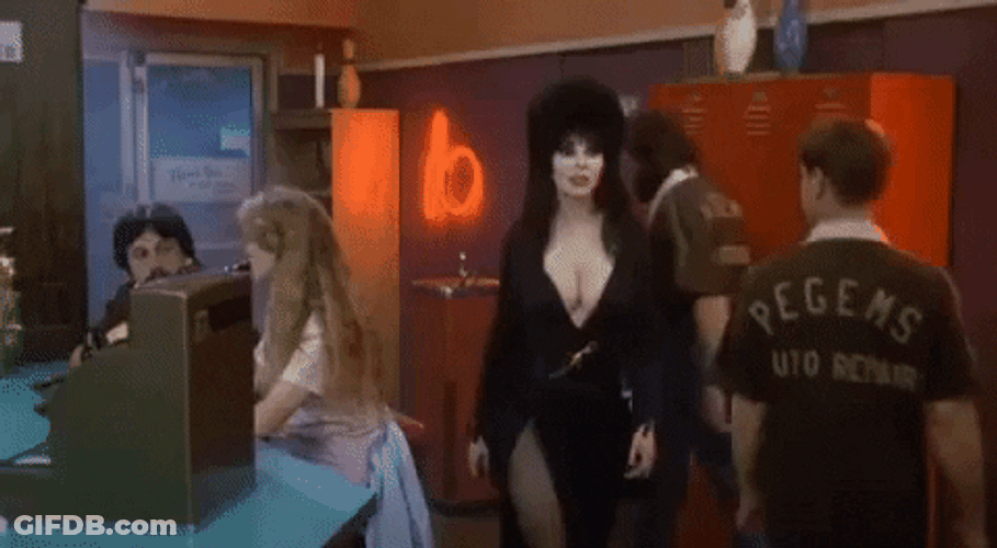 Elvira Looking Around And Smirking GIF