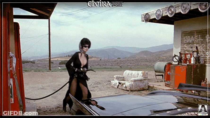 Elvira Trying To Fill Her Car Gas Tank GIF