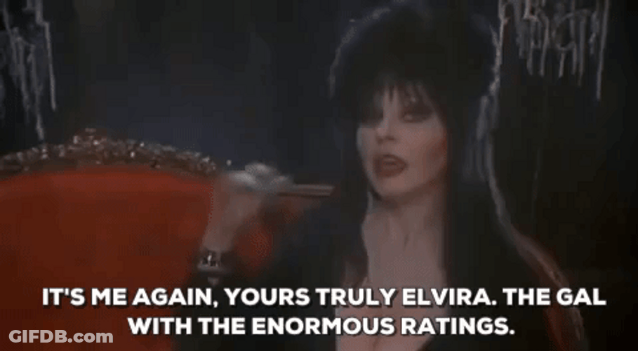 Elvira Waving And Introducing Herself GIF