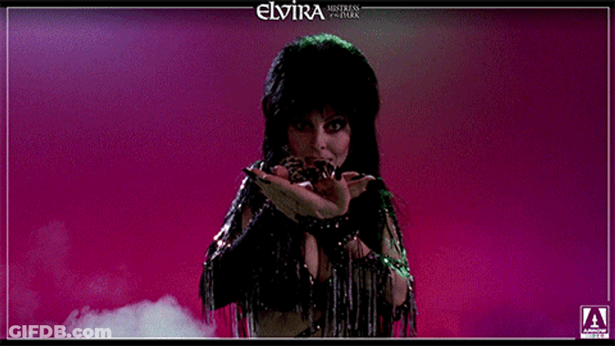 Elvira With A Spider On Her Palm GIF
