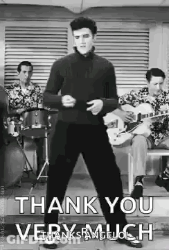 Elvis Presley Is Dancing In Front Of A Group Of Men Playing Drums And Guitars In A Black And White Photo . GIF