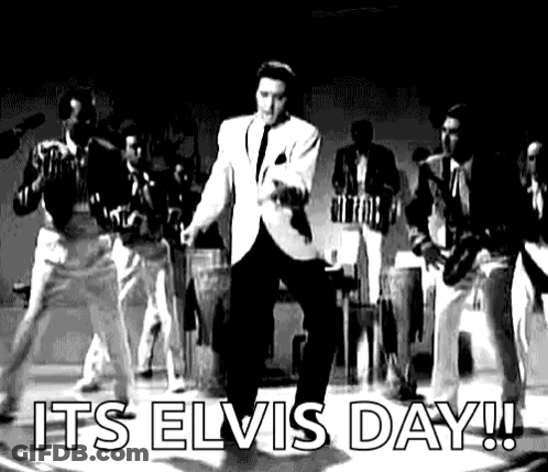 Elvis Presley Is Dancing On Stage In A Black And White Photo With A Band Behind Him . GIF