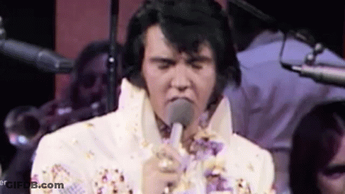 Elvis Presley Singing Into Microphone In White Suit GIF