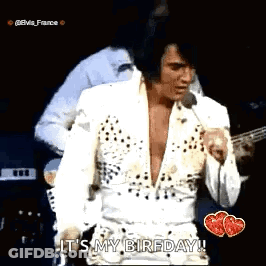 Elvis Presley Standing On Stage Singing Into Microphone GIF