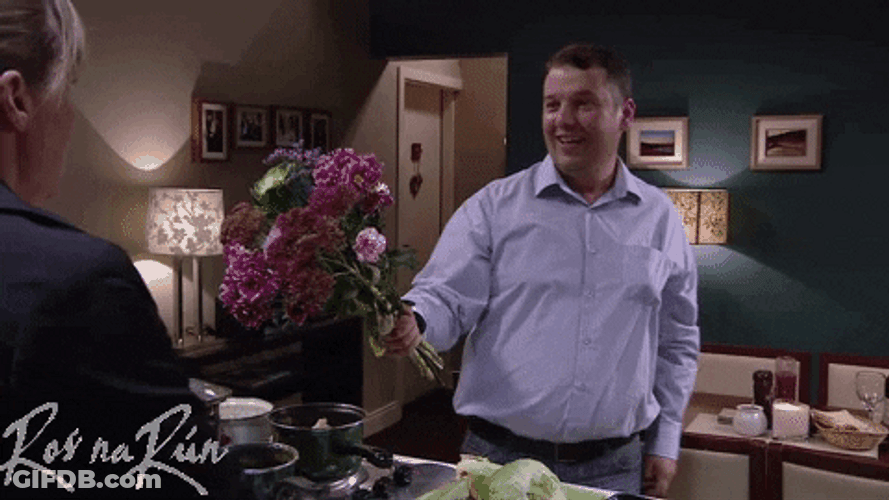 Embarrassed Man Giving Flowers GIF