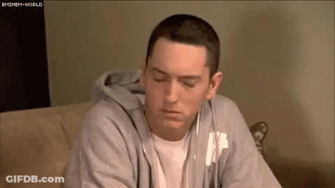 Eminem On Couch Wearing Headphones And Hoodie GIF