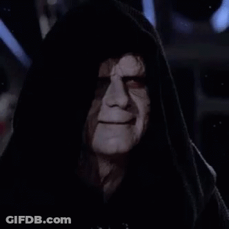 Emperor Palpatine From Star Wars Is Wearing A Hooded Robe And Looking At The Camera In The Dark . GIF