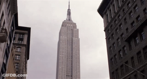 Empire State Building Surrounded By Tall Buildings GIF
