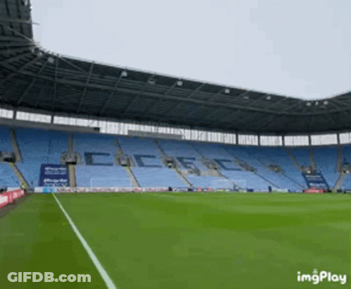 Empty Soccer Stadium With Coca-Cola On Stands GIF