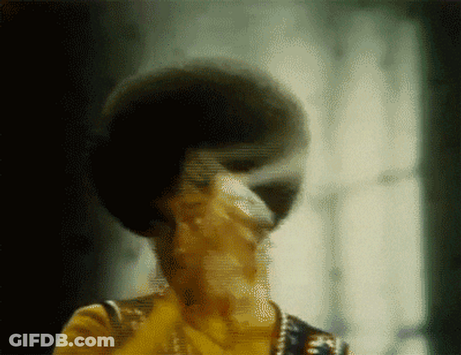 Enhancing Afro Hair Spray Application GIF