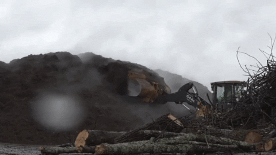 Excavator Making Mountains Of Mulch GIF